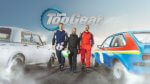 three hosts of Top Gear shown between two gunning cars