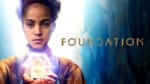 Woman holding glowing box and logo for series Foundation