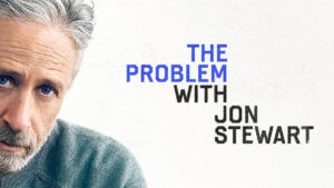 Jon Stewart looking at camera with show logo