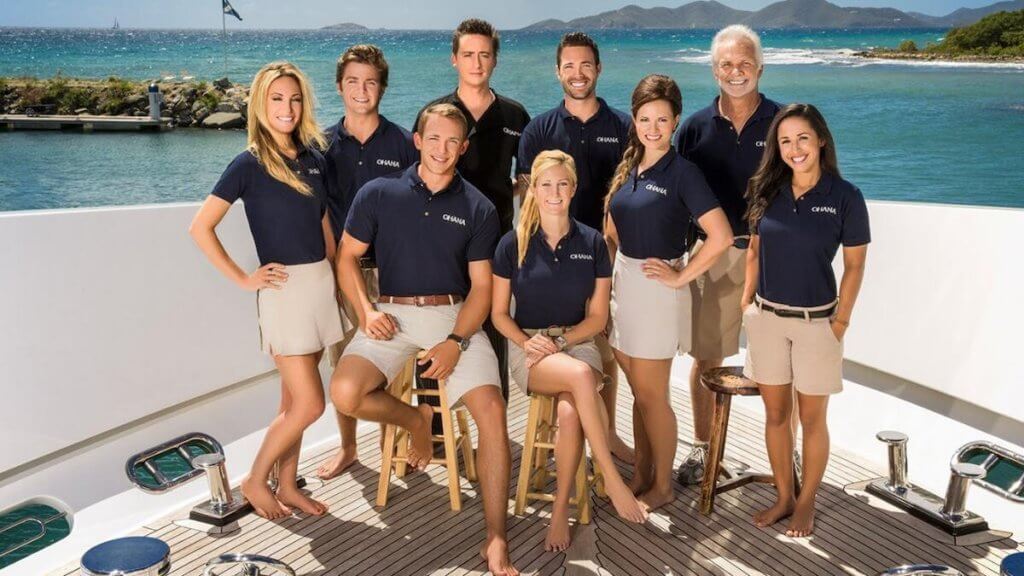 The cast/crew of Below Deck pictured on a boat deck