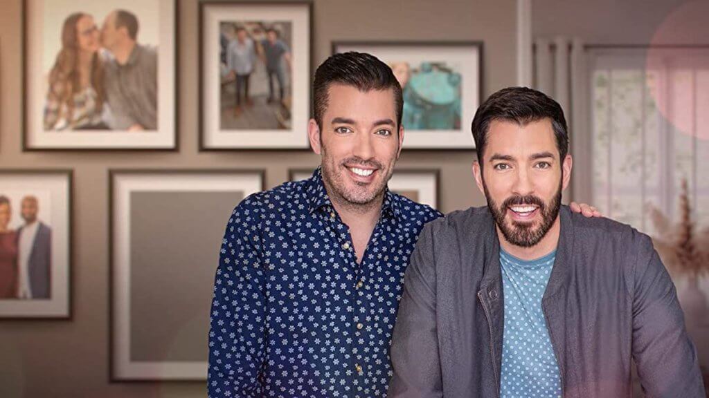 Two men facing the camera in a well-decorated home