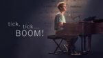 Actor seated at a piano by title Tick, Tick...Boom!