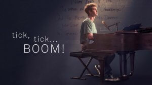 Actor seated at a piano by title Tick, Tick...Boom!