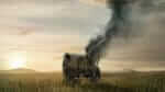 A burning wagon on a deserted western landscape