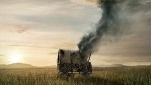 A burning wagon on a deserted western landscape