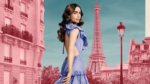 Lily Collins as Emily in front of pink and blue paris city scape