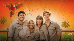 The Irwin family in front of a zoo sunset with a tropical bird
