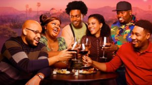 A group of friends toasting with wine in front of LA sunset