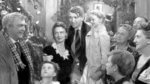 The Bailey family gathered by the tree in It's a Wonderful Life