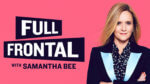 Samantha Bee stands with her arms crossed over a suit jacket looking at camera with a pink background