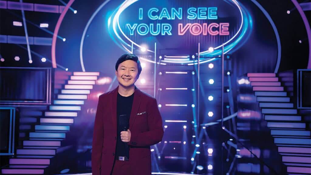 Host Ken Jeong in front of the set for I Can See Your Voice