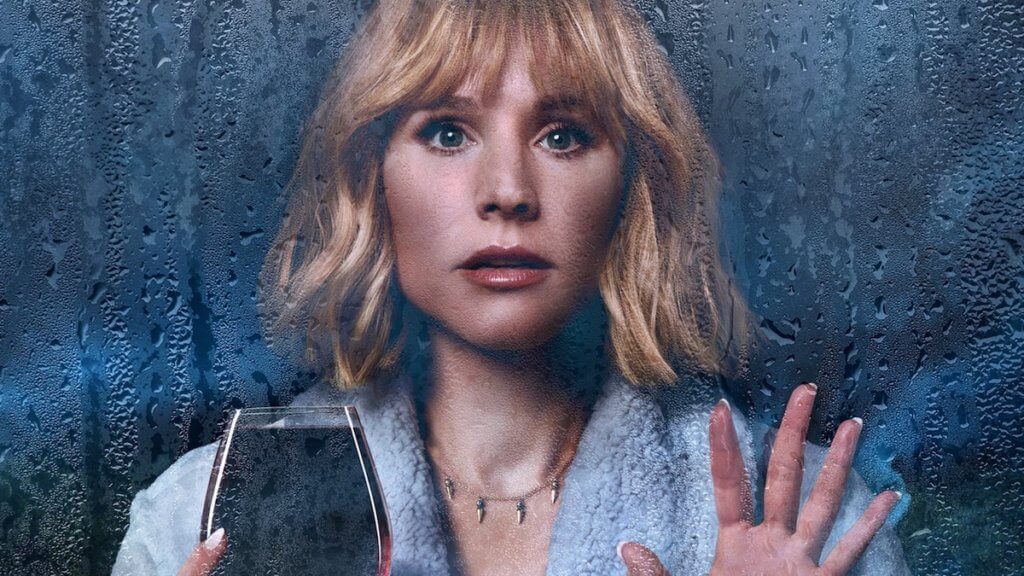 A blonde woman looks out a rainy window holding an overly full glass of wine