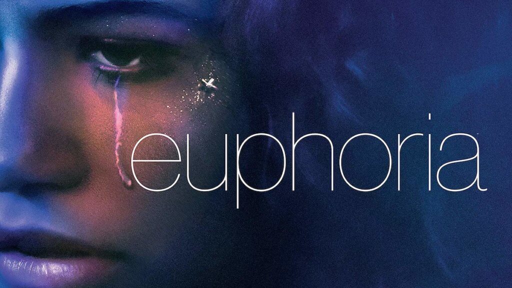 A close up of a woman's face with a tear streak and word Euphoria