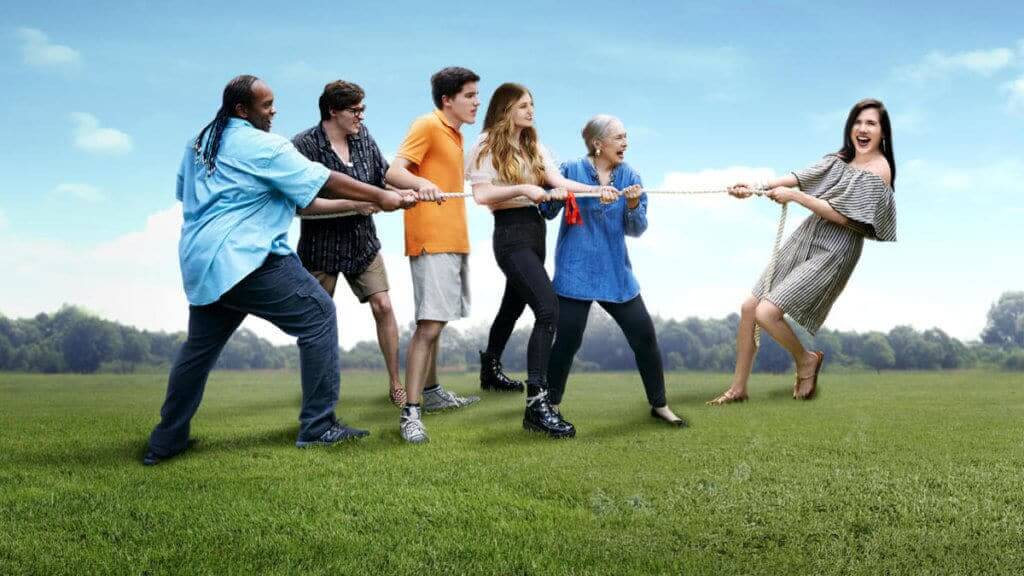 A woman plays tug-of-war with a family on the other side