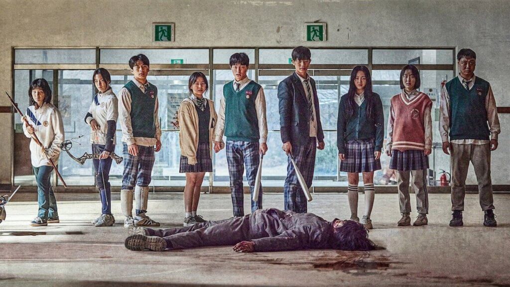 A group of Korean teens stand over the body of a zombie