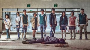 A group of Korean teens stand over the body of a zombie