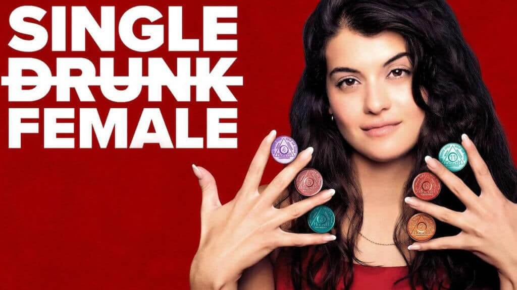 A young woman holds her hands with her fingers spread wide and AA chips between them