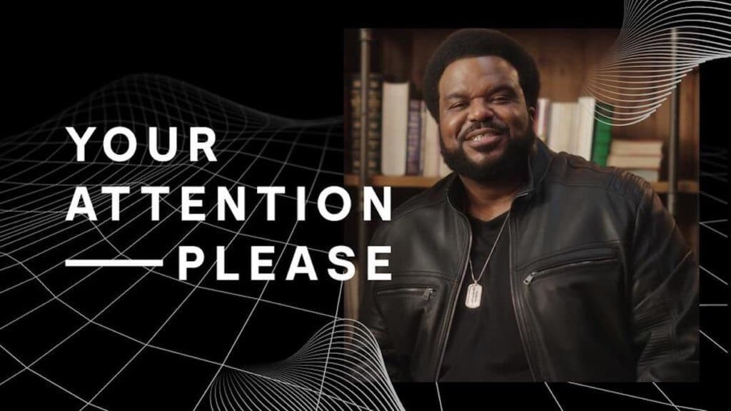 Actor craig robinson stands next to show text Your Attention Please