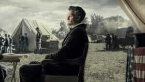 A layered photo of Abraham Lincoln in front of a civil war battle camp