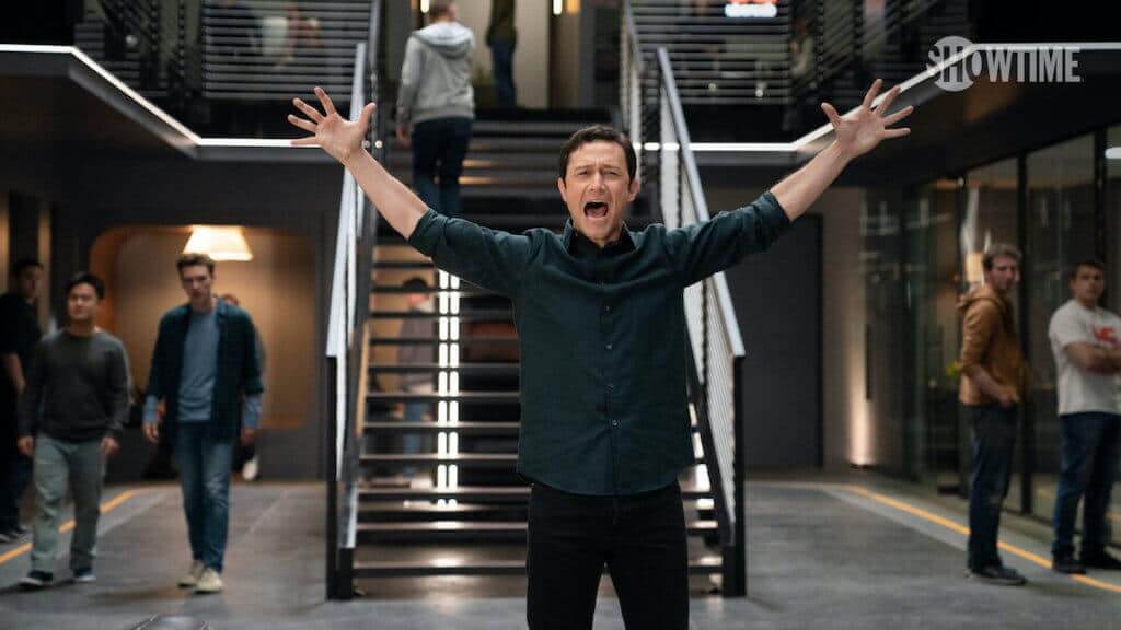 a man stands in front of a posh building elevator with his arms thrown out