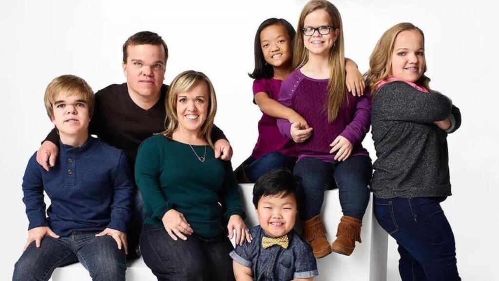 The 7-member Johnston family posed on a white background