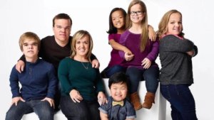 The 7-member Johnston family posed on a white background