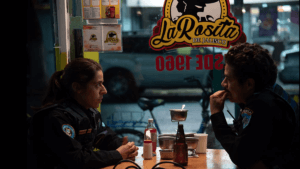 Two police officers sit across from each other in a small eatery