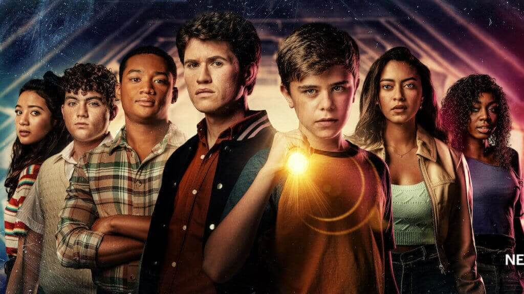A group of teens behind a boy holding a flashlight