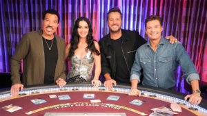 Host and judges of American Idol at a blackjack table