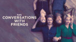 two couples lie on the floor with their hands intertwined