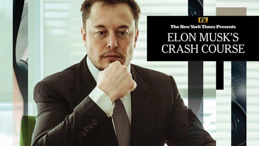 Elon Musk sitting at a desk