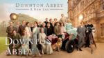 the full cast of Downton abbey posed with movie cameras