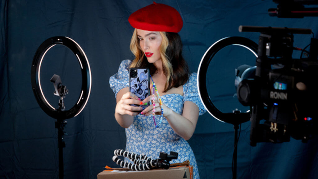 A woman staging a photo with ring lights