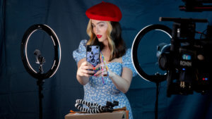 A woman staging a photo with ring lights