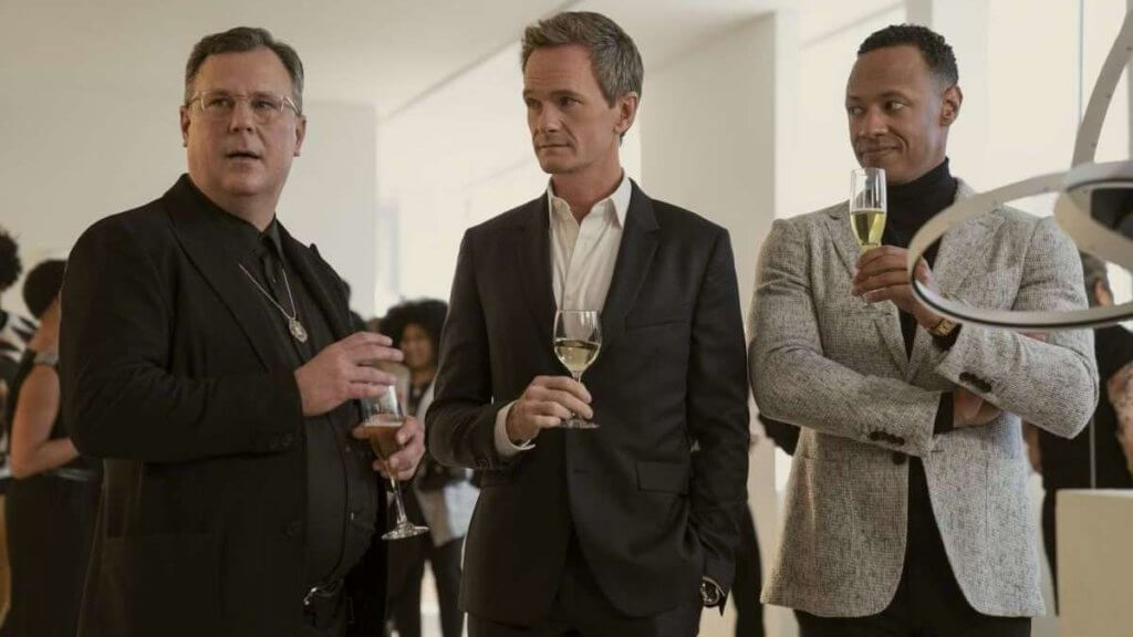 Three gay men at a party holding wine