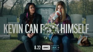 two women sit in front of a gravestone