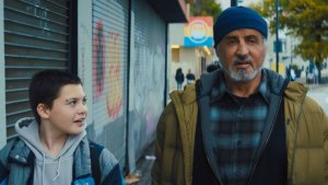 An older man and young boy walking down a city street