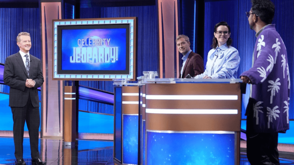 Host Ken Jennings and three celebrities on the Jeopardy set.