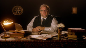 Director Guillermo del toro sits at an old fashioned desk
