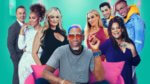 A group of celebrities around a pink chair with teal background
