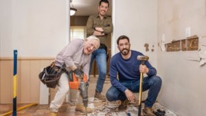 a diminutive older man and a pair of twins doing home renovation
