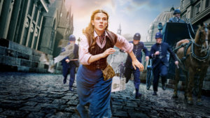 A young woman running through victorian streets with figures chasing her