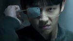 A Korean man pulling a futuristic patch off one eye