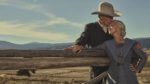 An older couple at a western fence post in the early 20th century