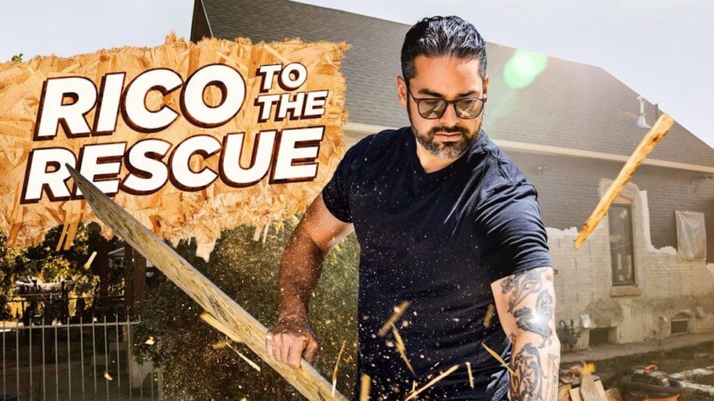 A tattooed contractor sawing up a piece of wood with cool protective shades