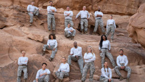 A group of fit people in military wear on a desert rock face