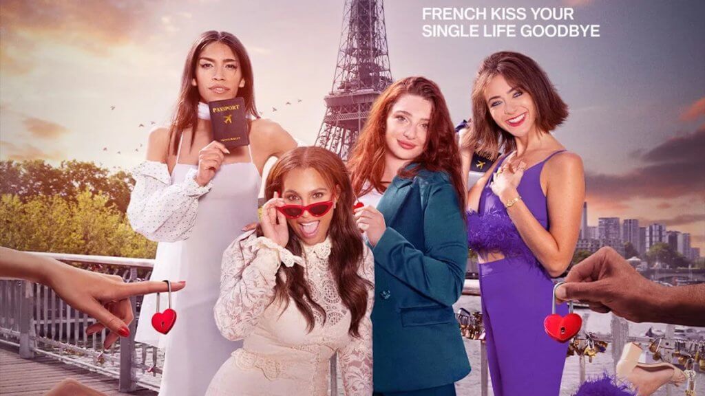 Four girls on a bridge in front of Eiffel tower with hands off-screen offering heart-shaped locks