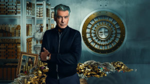 Actor Pierce Brosnan in front of a vault full of gold bricks