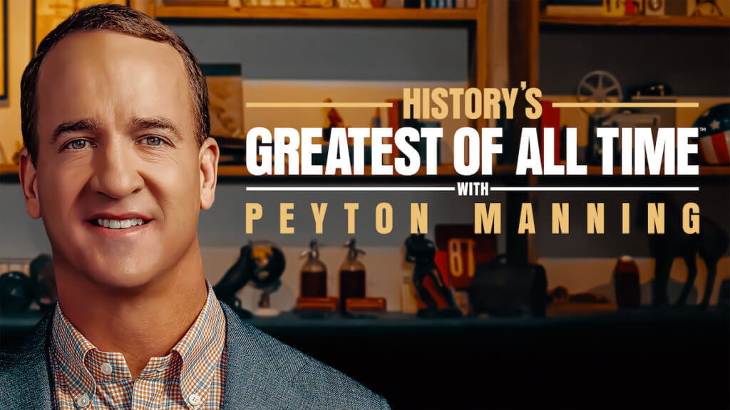Sports legend Peyton Manning in front of a shelf of iconic memorabilia