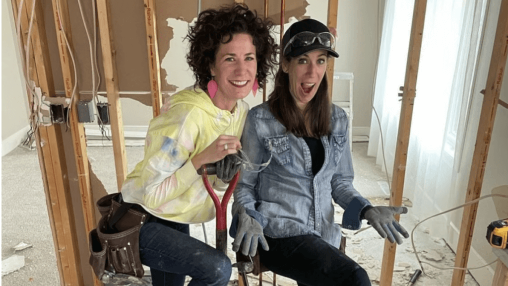 Two brunettes sisters in the midst of a home renovation construction